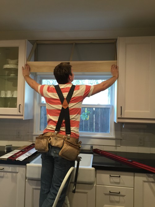 Measuring the frame he built.