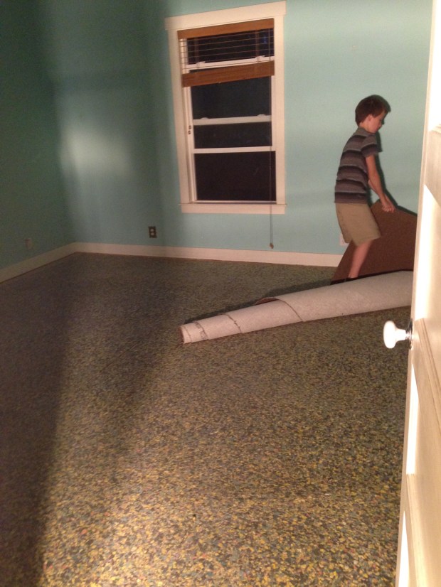 Caleb removing the carpet from the master bedroom. 