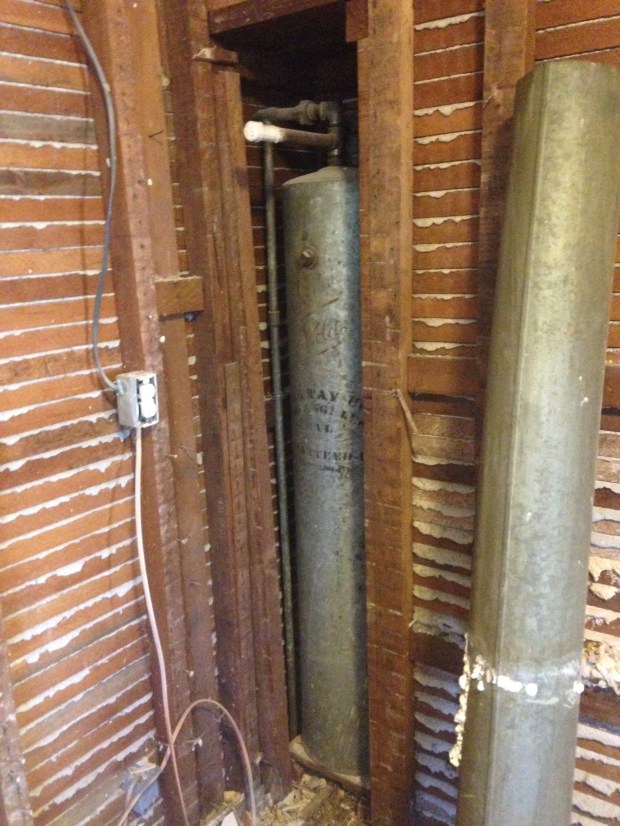 An old water softener hidden behind the walls. 