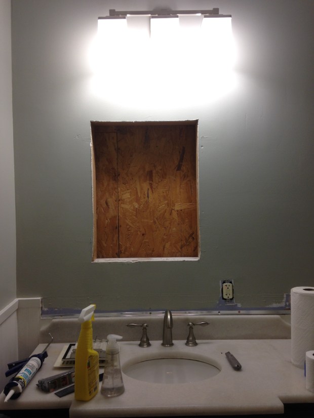 Removed the medicine cabinet and didn't even bother patching the hole because it will be hidden behind the new mirror. Notice how off center it was!