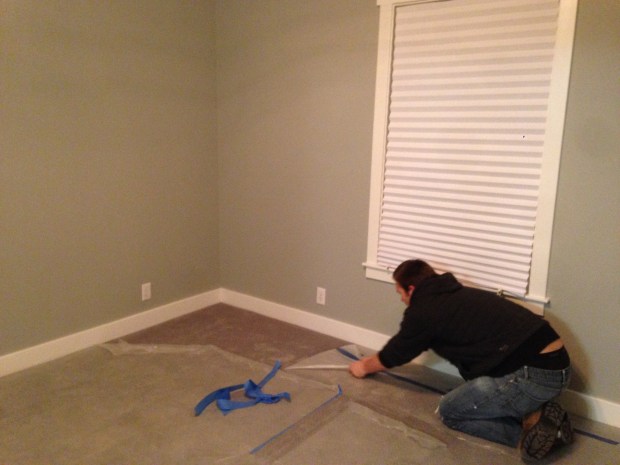 Kevin removing the plastic off our carpet. 