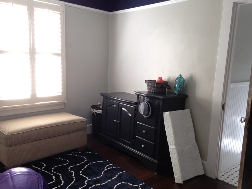 Newly painted changing table/dresser. You can also catch a glimpse of the new navy accent above the plate rail.